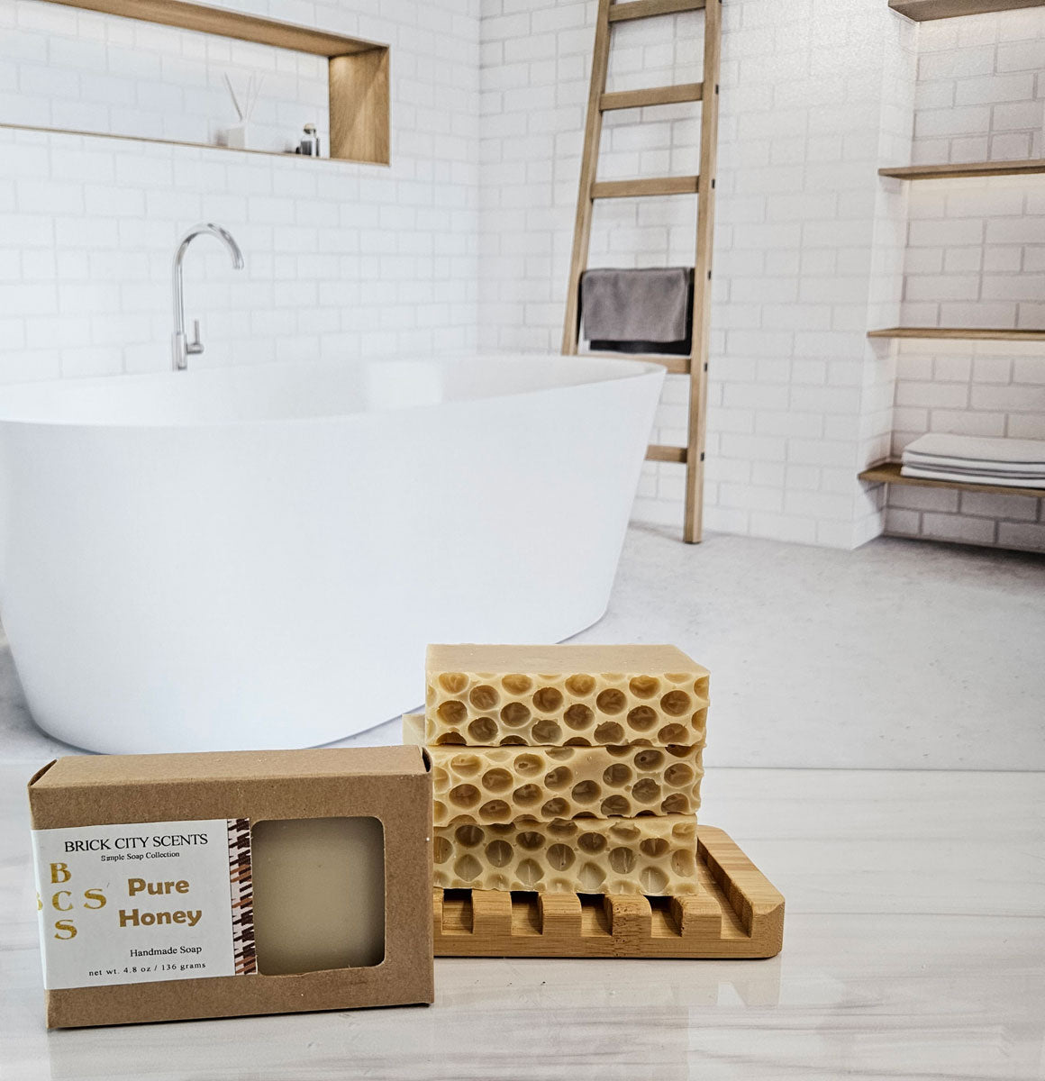 Brick City Scents Pure Honey Handmade Soap on a wooden soap dish next to the boxed soap.