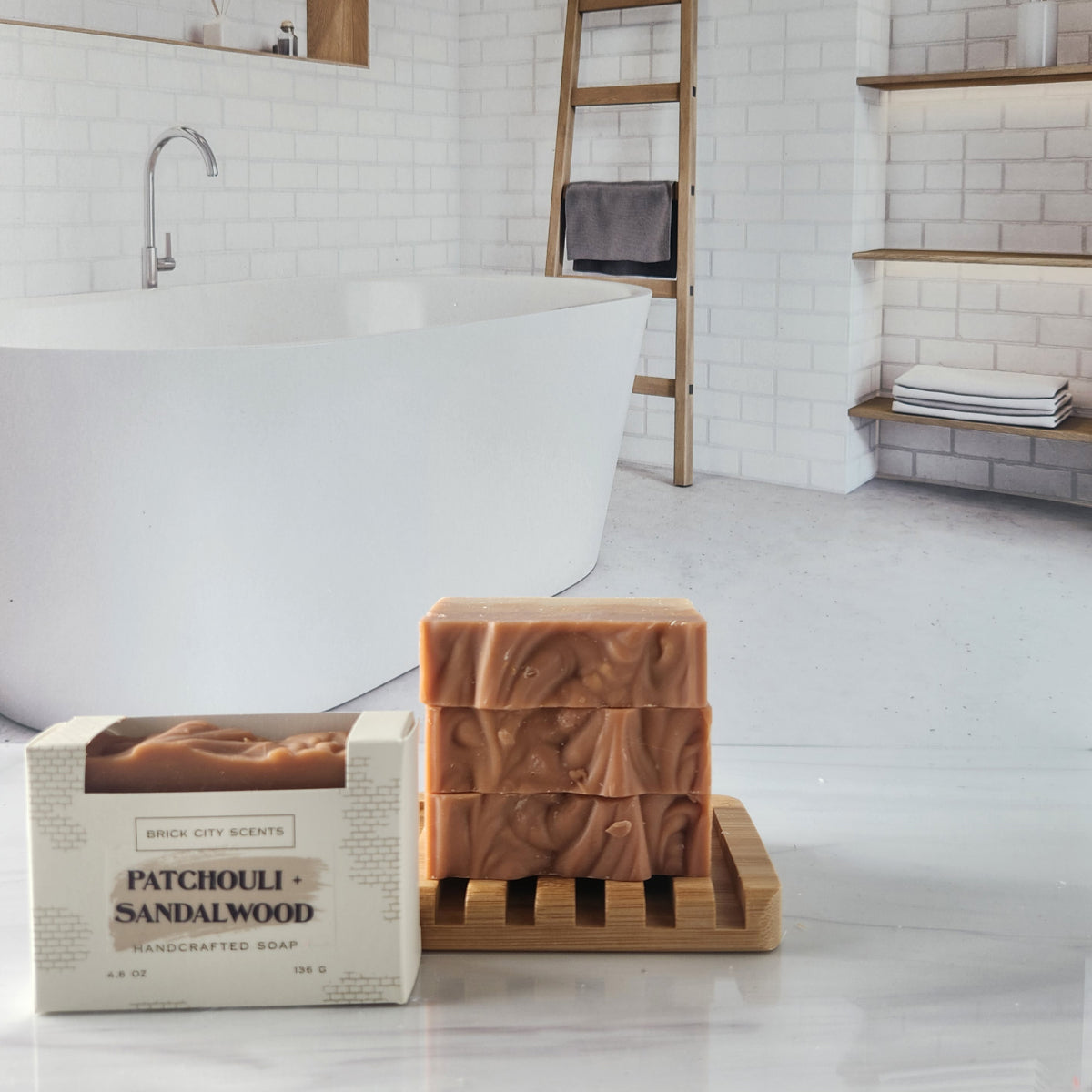 Brick City Scents patchouli sandalwood soap bars stacked on a wooden holder with boxed soap.