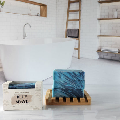 Brick City Scents Blue Agave handcrafted soap bars stacked on a wooden holder, with product packaging.
