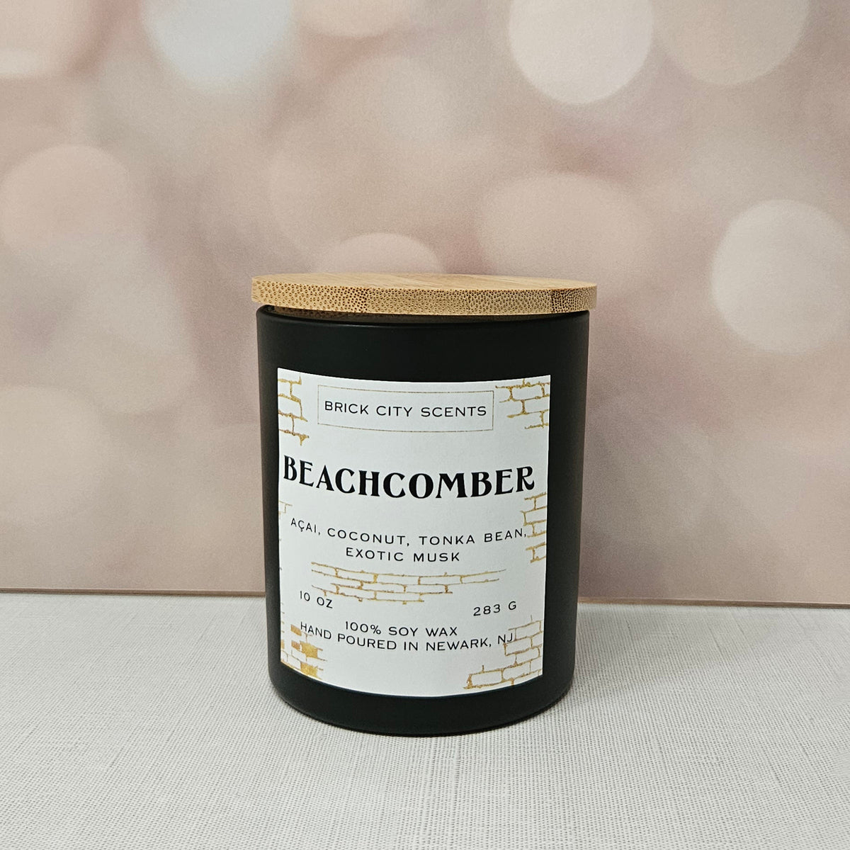 Brick City Scents Beachcomber candle with a wooden lid. Scent notes include acai, coconut, tonka bean, and exotic musk. 10 oz, 100% soy wax.