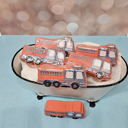 Fire truck bath bombs in a miniature bathtub. Fun, themed bath products.