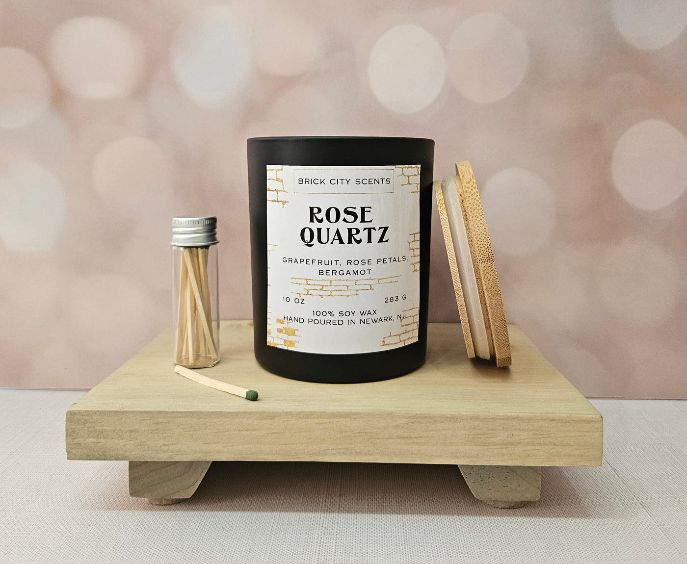 Brick City Scents Rose Quartz candle with grapefruit, rose petals, and bergamot. Includes matches and a wooden lid.