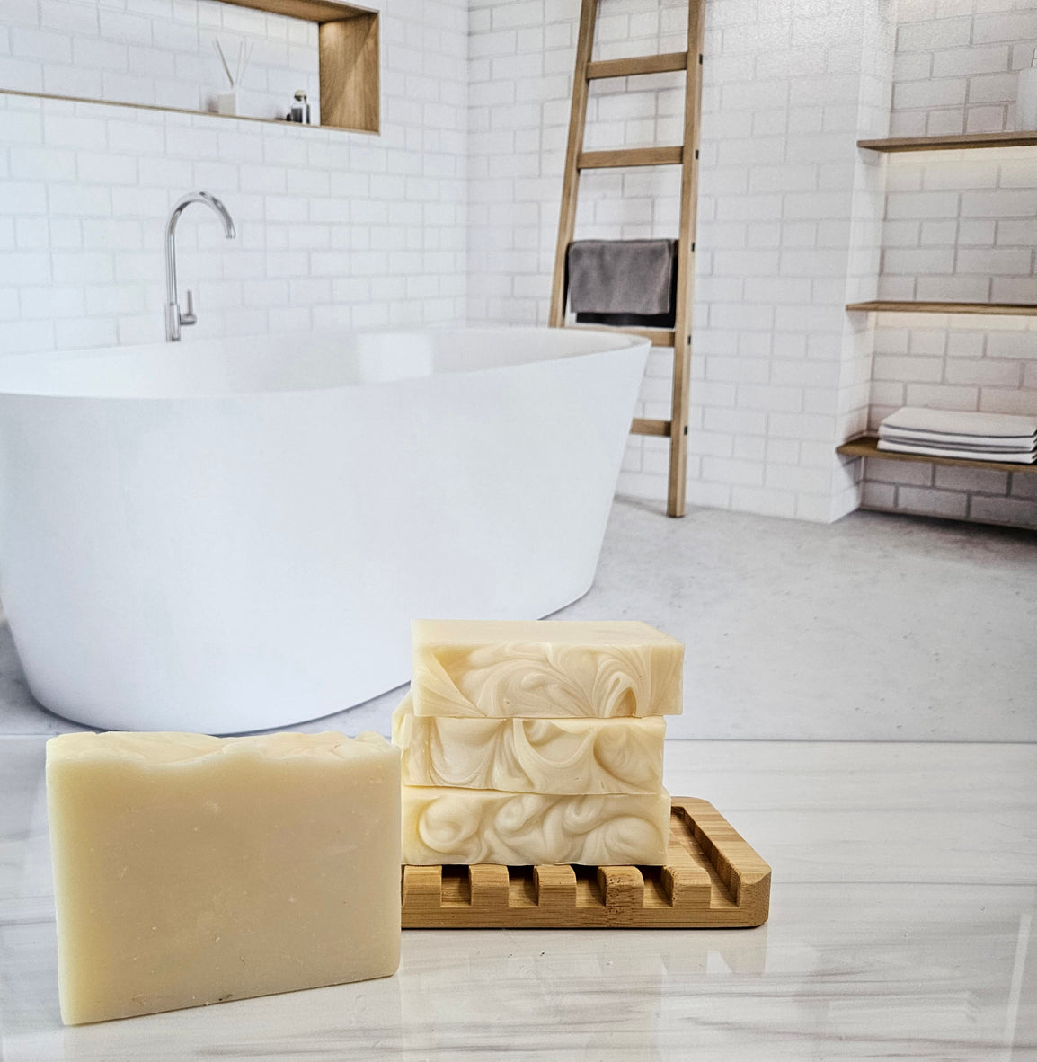 Unscented triple butter soap bars made with shea, cocoa, and mango butter on a wooden soap dish.